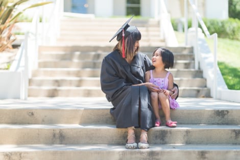 A mother and daughter sitting on campus steps together