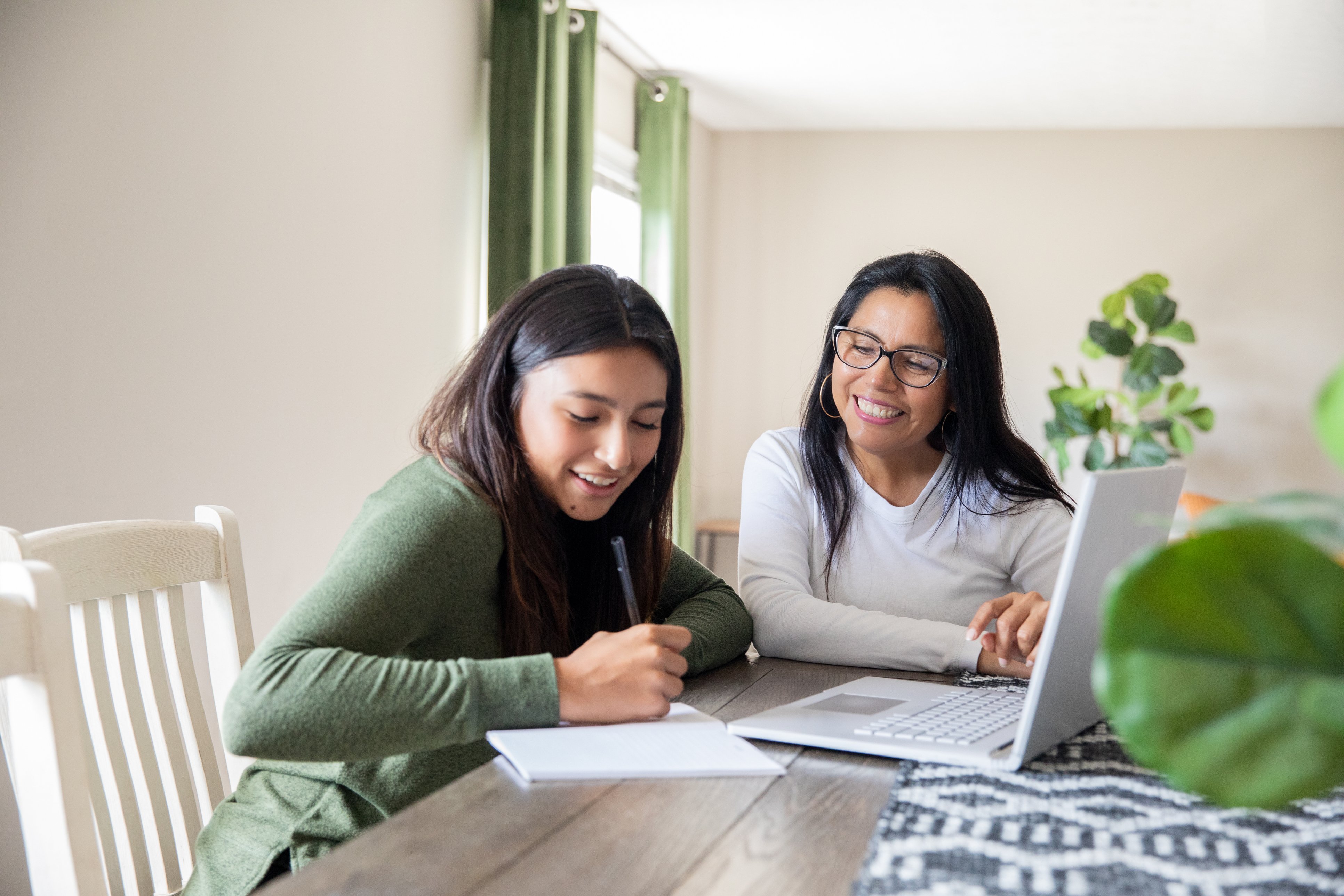 Mother teaching teenager about finances