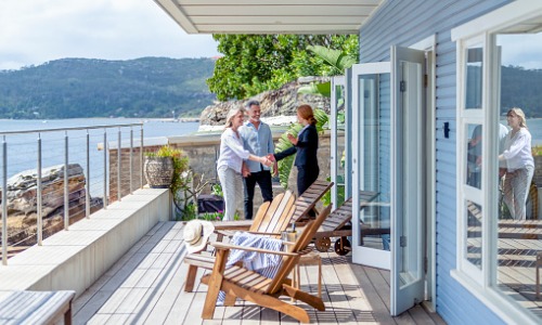 Real estate agent showing couple vacation home
