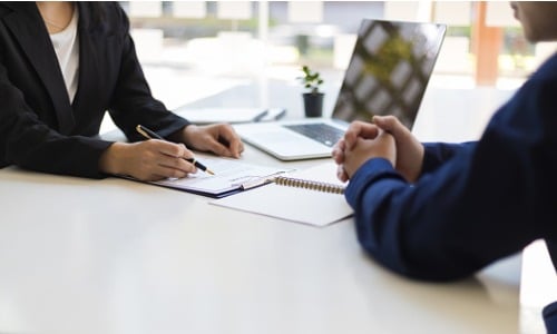 Manager interviewing new employee with resume