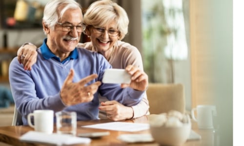 Senior couple using cell phone