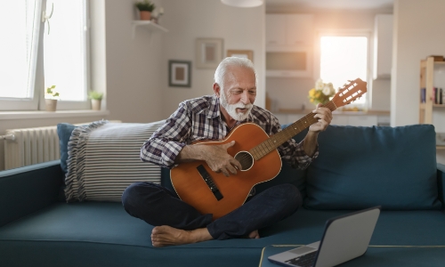 Senior gentleman playing the guitar