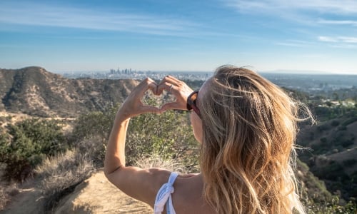 Woman standing on top of a mountain