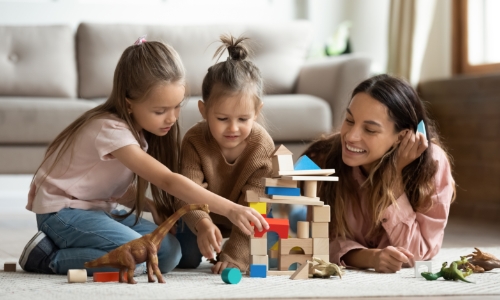 Babysitter playing with 2 young girls