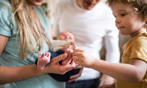 Family holding a new baby