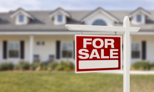 For sale sign in front of a house