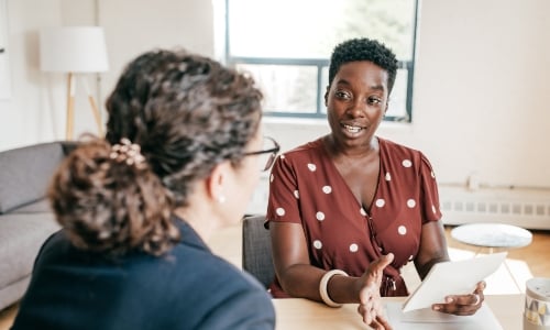 Two colleagues discussing a business deal