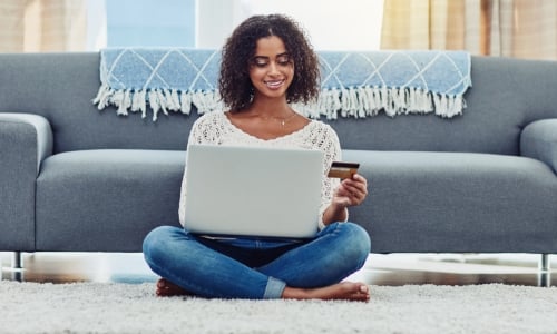 Woman using her credit card to shop online