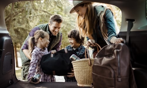 A family packing the car for a road trip