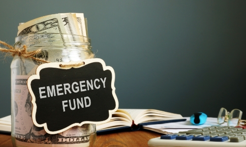 A jar of money labeled emergency fund
