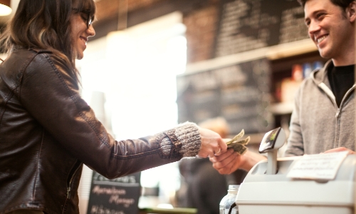 Woman paying for a purchase with cash