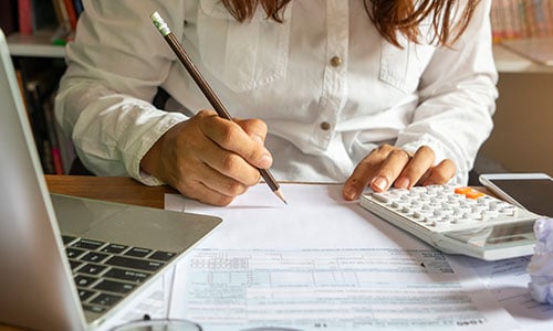 Woman planning out her budget.