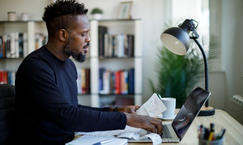 Man managing finances and filing tax return