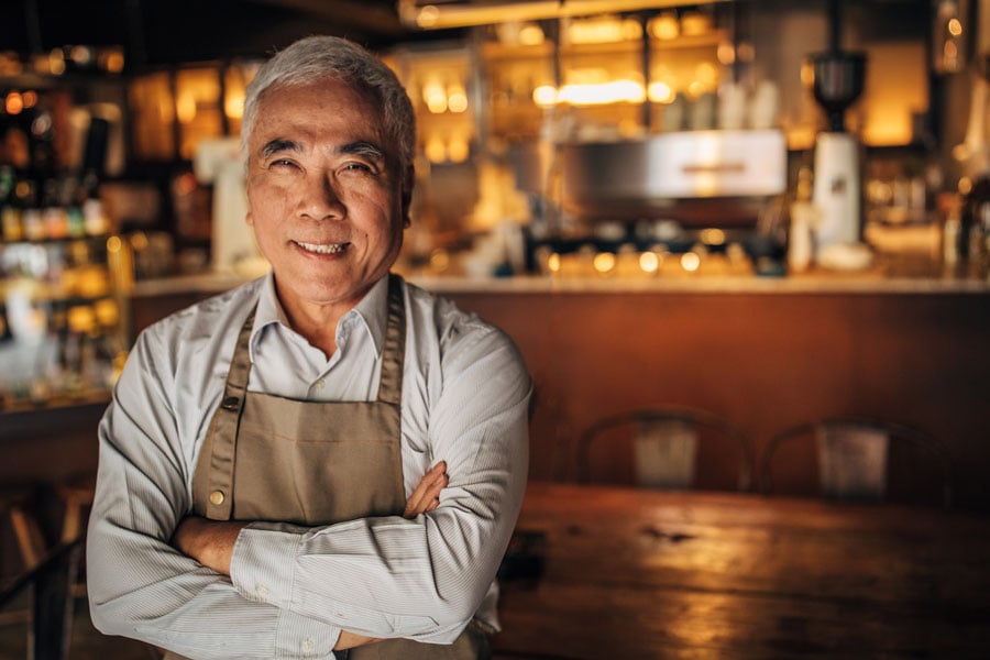 Business owner posing in his restaurant