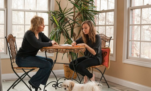 Mother helping daughter with finances