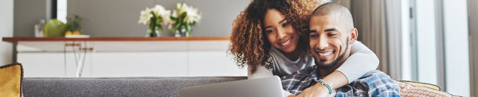 A couple looking at a laptop screen