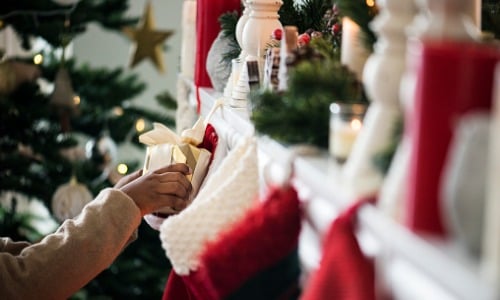 Putting gift in Christmas stocking