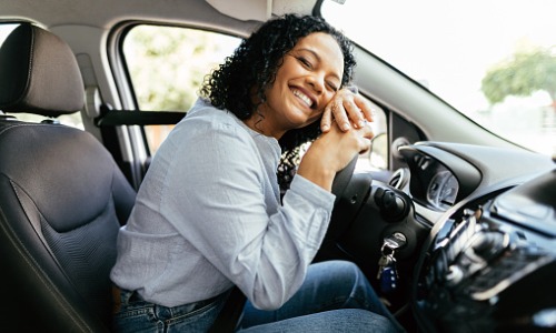 Young woman enjoying new car