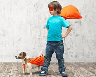 Boy and his dog in superhero capes