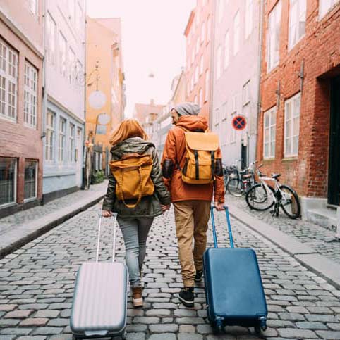 couple working down the street with luggage