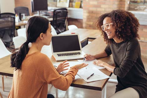 two women from different ethnicities collaborating together