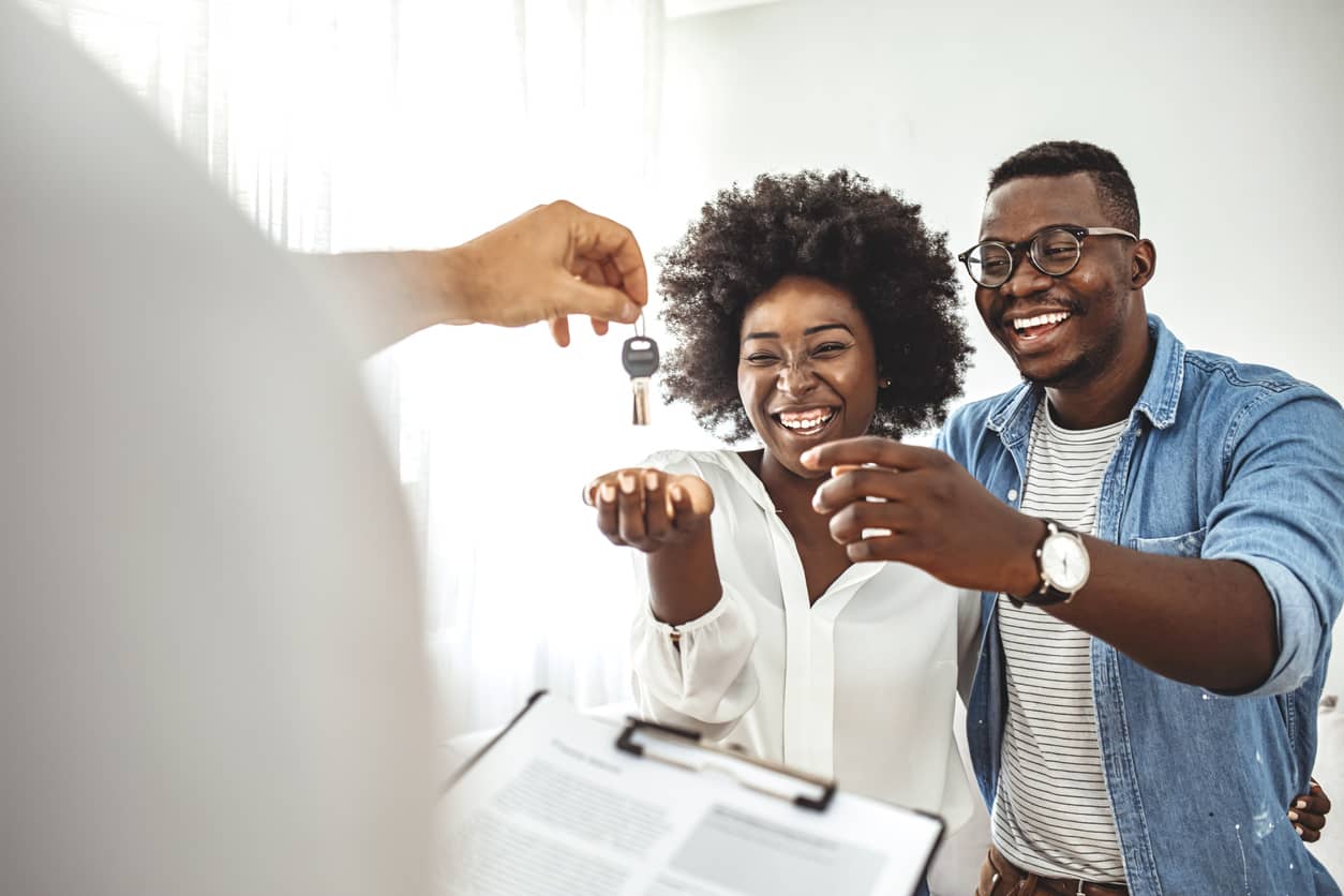 a couple receiving keys to their house
