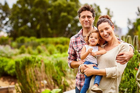 a small family standing outdoors