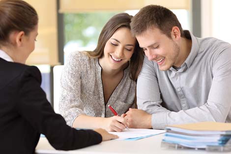 A couple signing paperwork