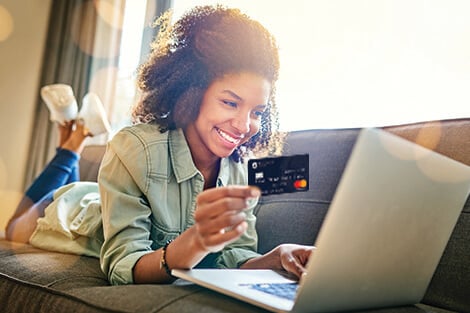 woman making a purchase online with her credit card