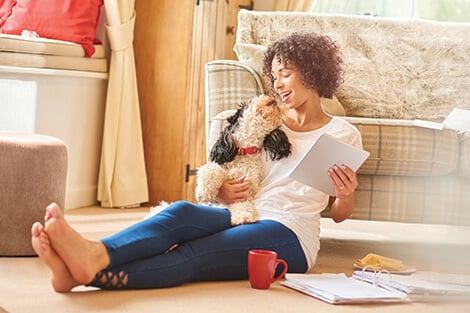 Land your dream home with a Jefferson Bank mortgage woman sitting in her new home