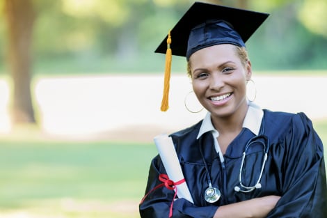 a medical student smiling with her diploma