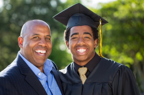 A father and son smiling together at graduation