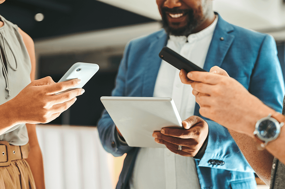 A group of people holding phones and a tablet