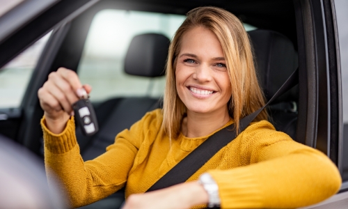 Lady holding the keys to her new car
