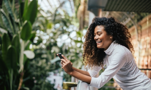 Woman on a deck shopping on her phone