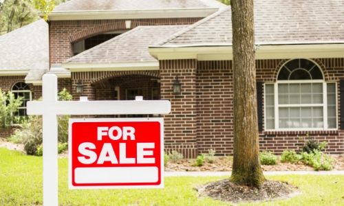 For sale sign in front of a house