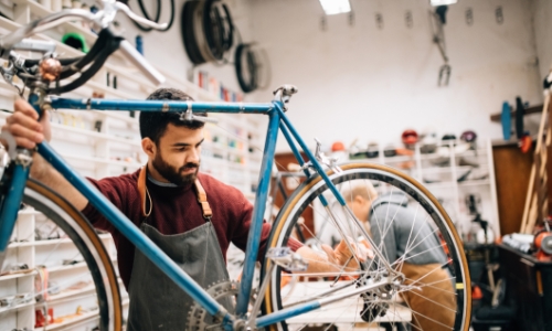 Man fixing a bicycle in a shop