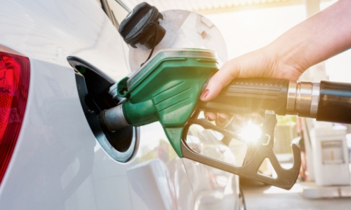 Close up of a woman pumping gas into a vehicle