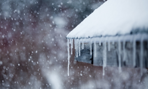 Close up of a roof with snow and ice