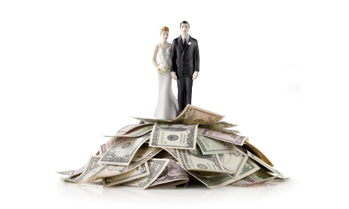 Wedding couple statue on top of a pile of cash