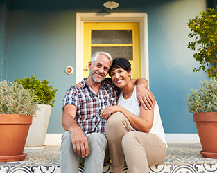 A couple sitting on their front porch
